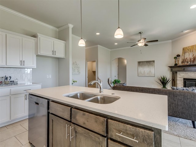 kitchen featuring dishwasher, pendant lighting, white cabinetry, and sink