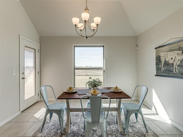 tiled dining area with a chandelier, a healthy amount of sunlight, and vaulted ceiling