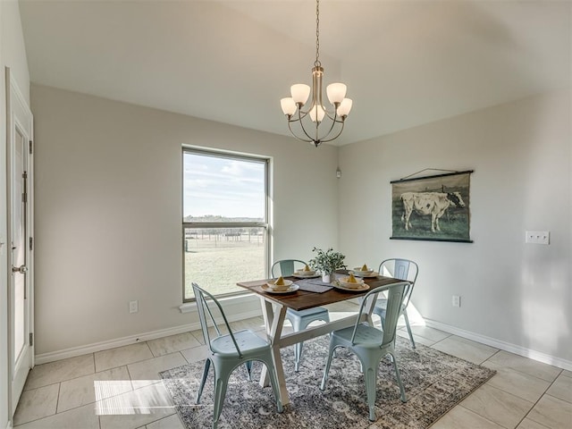 tiled dining room featuring a chandelier