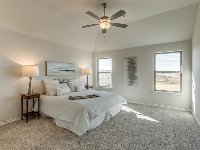 carpeted bedroom with vaulted ceiling, multiple windows, and ceiling fan