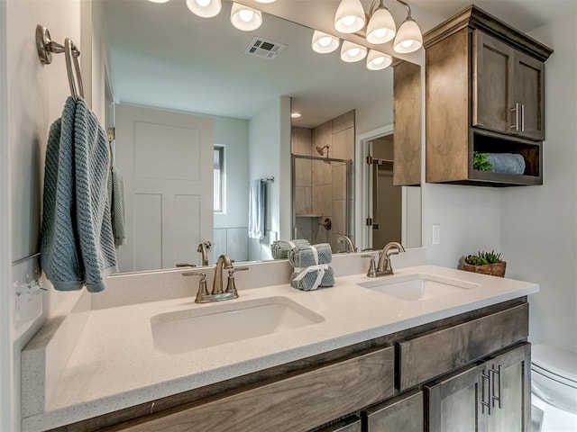 bathroom featuring vanity, an inviting chandelier, toilet, and an enclosed shower