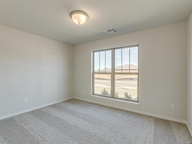 empty room featuring carpet and a mountain view