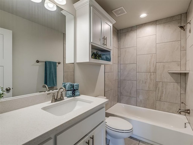 full bathroom with tiled shower / bath combo, toilet, and vanity