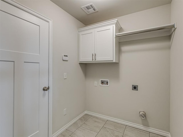 washroom with hookup for an electric dryer, cabinets, and washer hookup