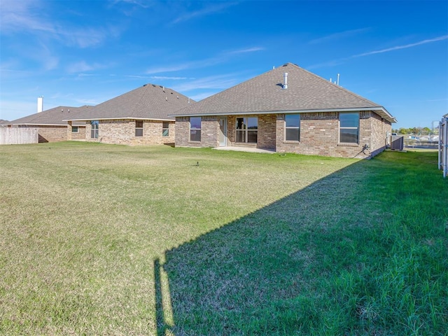 rear view of property with a lawn