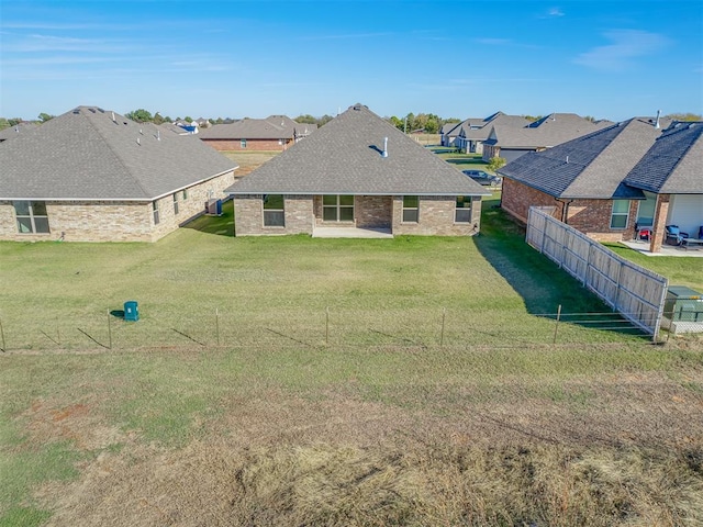 back of property featuring a yard and a patio