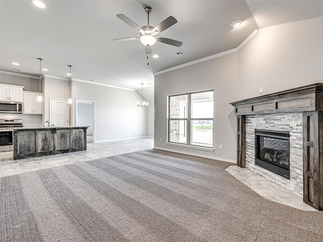 unfurnished living room with a stone fireplace, crown molding, light colored carpet, vaulted ceiling, and ceiling fan with notable chandelier