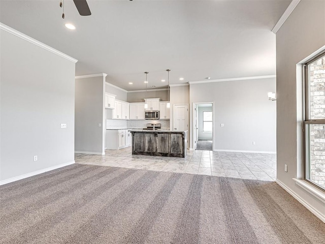 unfurnished living room with a healthy amount of sunlight, light colored carpet, and crown molding