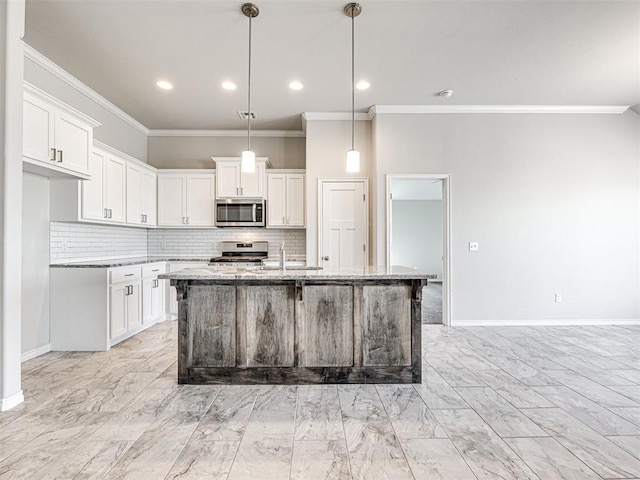 kitchen featuring a kitchen island with sink, white cabinets, hanging light fixtures, appliances with stainless steel finishes, and light stone counters