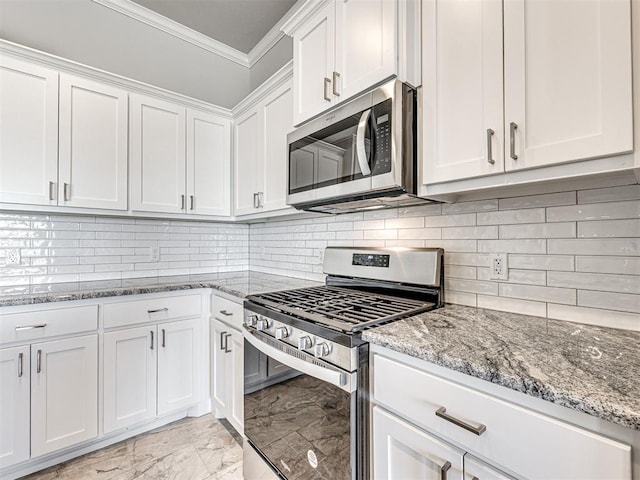 kitchen featuring light stone countertops, stainless steel appliances, tasteful backsplash, crown molding, and white cabinets