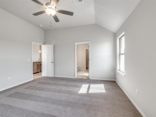 unfurnished bedroom featuring ceiling fan, light colored carpet, and lofted ceiling