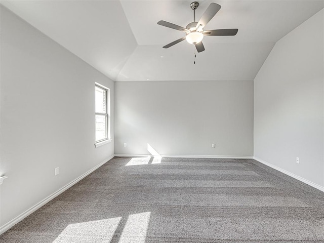 unfurnished room featuring carpet flooring, ceiling fan, and vaulted ceiling