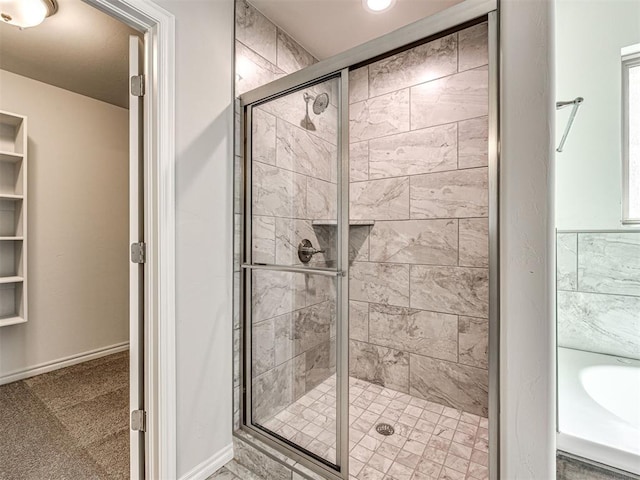 bathroom with a shower with door