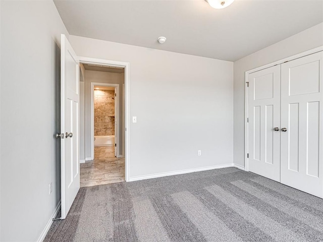 unfurnished bedroom with carpet flooring and a closet