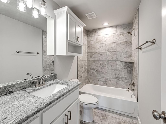 full bathroom with vanity, tiled shower / bath combo, and toilet