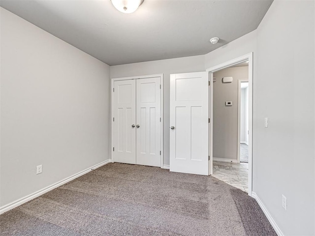 unfurnished bedroom featuring a closet and carpet