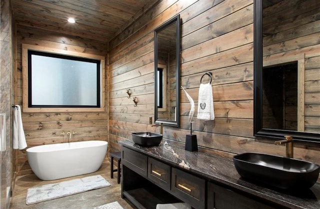 bathroom featuring vanity, a tub to relax in, wooden walls, and wood ceiling