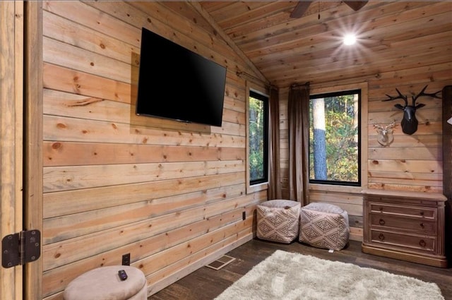 unfurnished bedroom with wooden walls, dark hardwood / wood-style floors, vaulted ceiling, and wooden ceiling