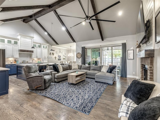 living room with dark hardwood / wood-style flooring, ceiling fan, beam ceiling, high vaulted ceiling, and a fireplace