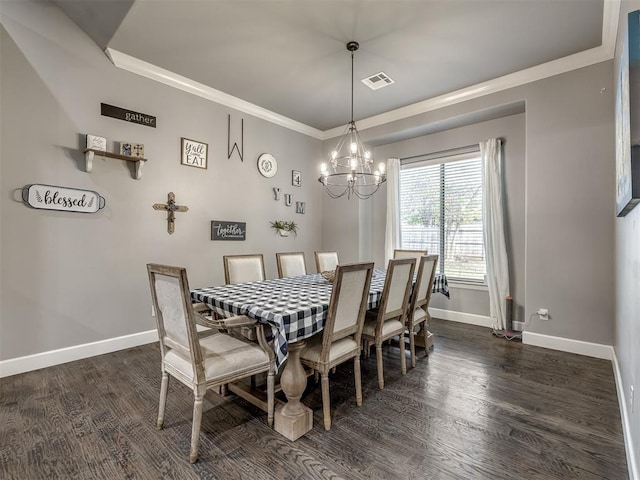 dining area with ornamental molding, dark wood-type flooring, and a notable chandelier