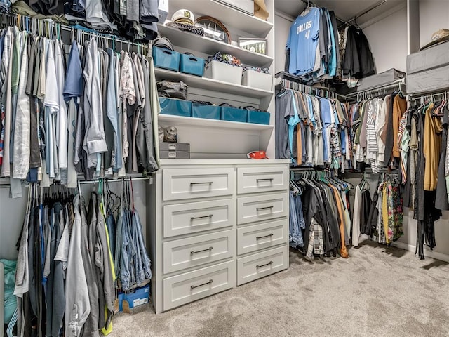 walk in closet featuring light carpet