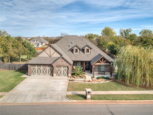 view of front of home featuring a front yard and a garage