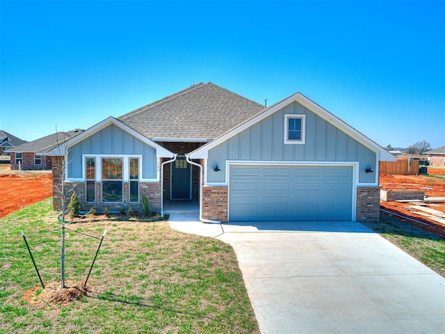 craftsman house featuring a garage and a front lawn