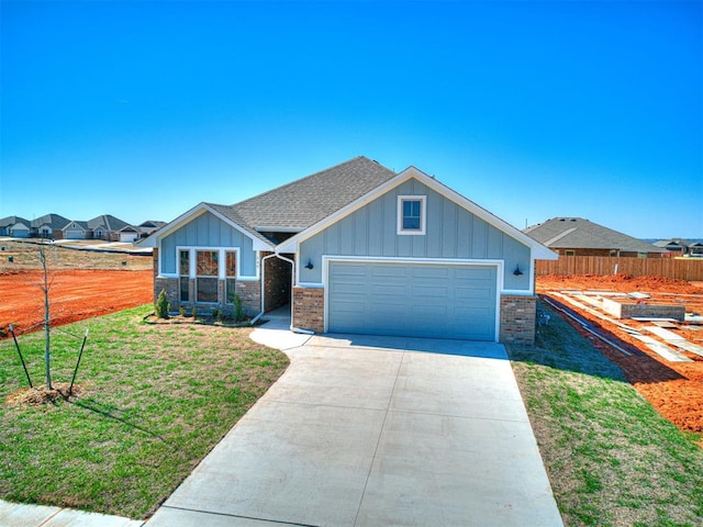 view of front facade with a garage and a front lawn