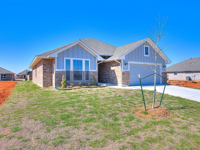 view of front of property featuring central AC unit, a garage, and a front yard