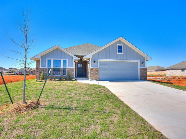 view of front of property featuring a garage and a front lawn