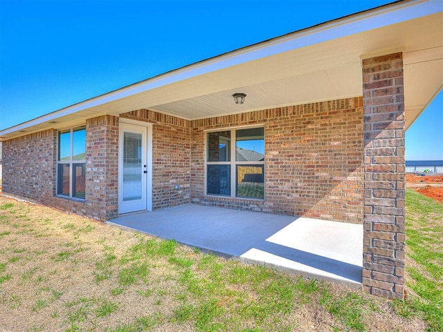 entrance to property featuring a patio area