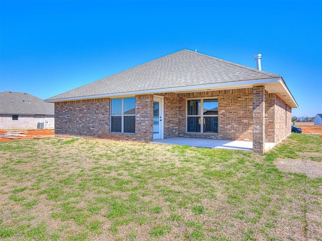 rear view of house with a patio area and a yard