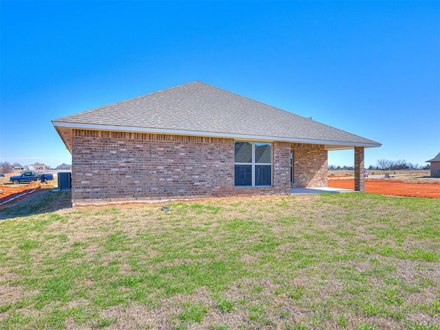 rear view of house with a yard, a patio, and central AC unit