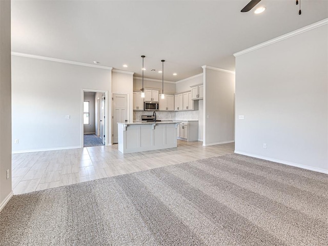 unfurnished living room with crown molding, ceiling fan, and light carpet