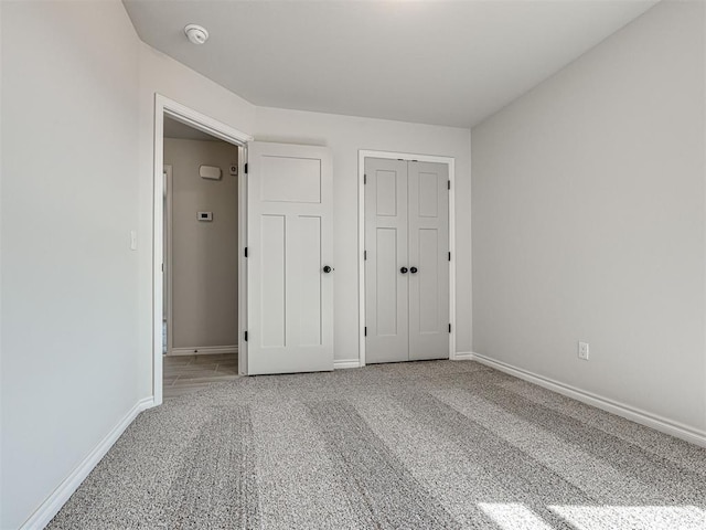 unfurnished bedroom with carpet floors and a closet