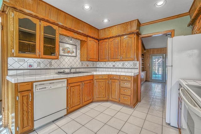 kitchen with tile counters, sink, white appliances, decorative backsplash, and light tile patterned flooring