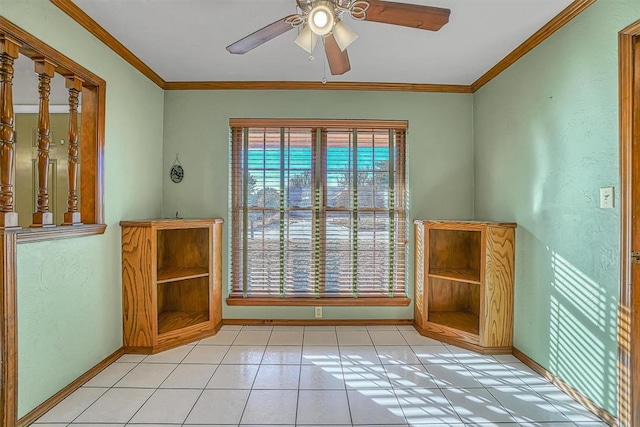 interior space with ceiling fan and ornamental molding