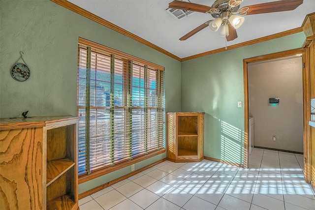 interior space with ceiling fan, light tile patterned floors, and crown molding