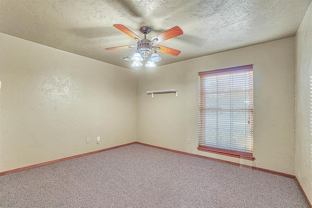 empty room featuring carpet flooring, ceiling fan, and a textured ceiling