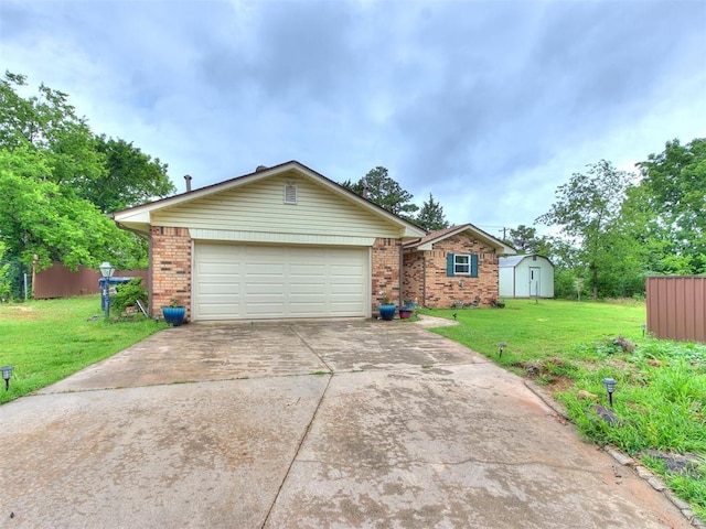 view of front of house featuring a garage, a front lawn, and a storage unit