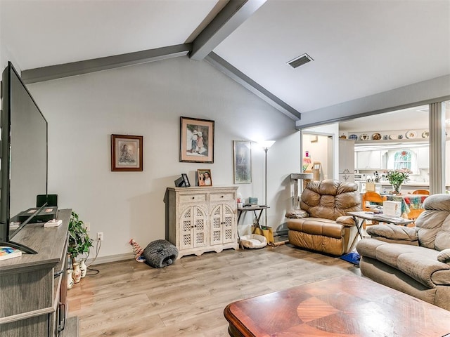 living room featuring vaulted ceiling with beams and light hardwood / wood-style floors