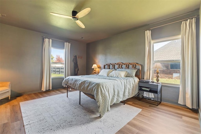 bedroom with ceiling fan and light wood-type flooring