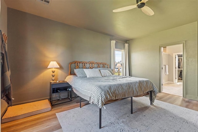 bedroom with ceiling fan and light wood-type flooring