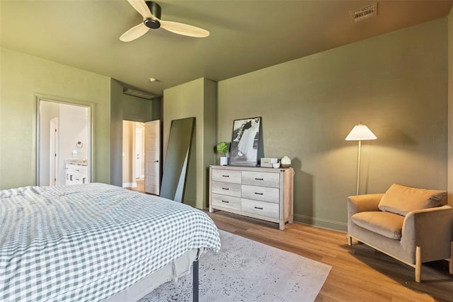 bedroom with light hardwood / wood-style flooring, ceiling fan, and ensuite bathroom