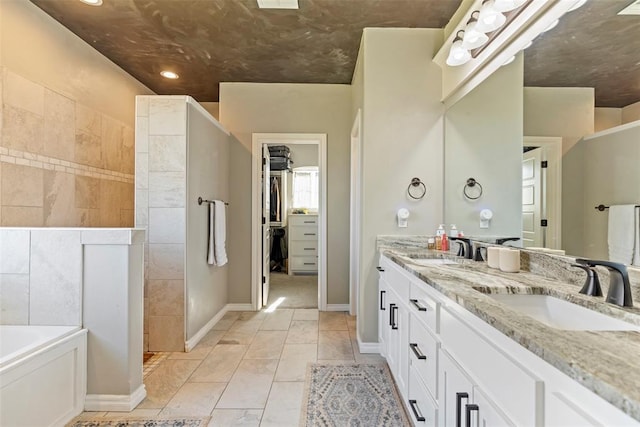 bathroom with vanity and a tub