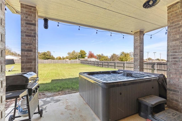 view of patio / terrace featuring a grill and a hot tub