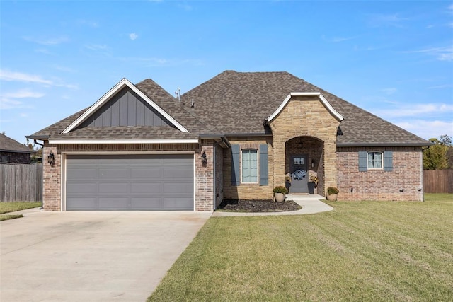 view of front of property with a garage and a front lawn