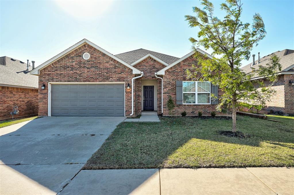 view of front facade with a front yard and a garage