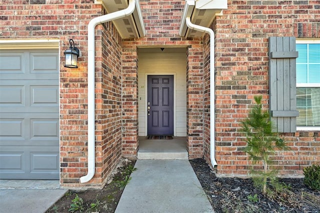 view of exterior entry with a garage