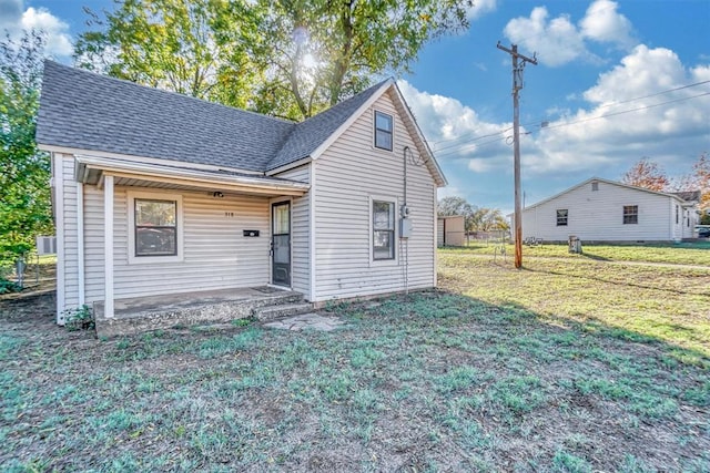 rear view of house with a yard